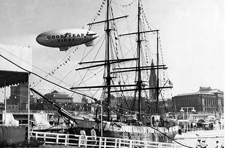 Goodyear blimp flies past a ship at the 1937 Great Lakes Exposition