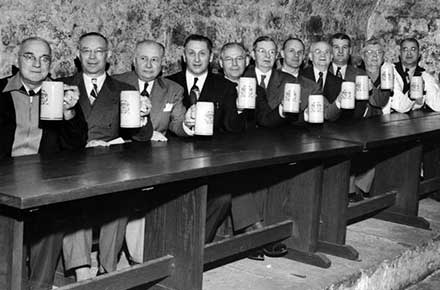 Brewery employees hoist a toast in rathskeller at Leisy Brewery, 1952