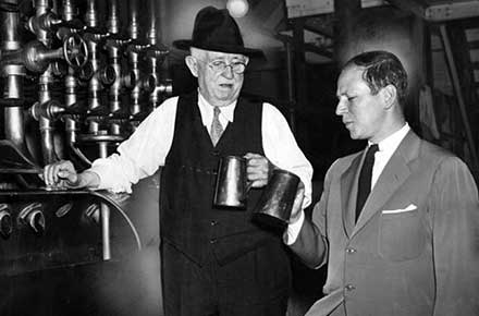 Herbert Leisy and brewmaster Carl Faller sample lager, 1939