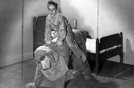 Michael being taken to bed by Nana, the dog nurse, in a scene from Peter Pan, 1942.