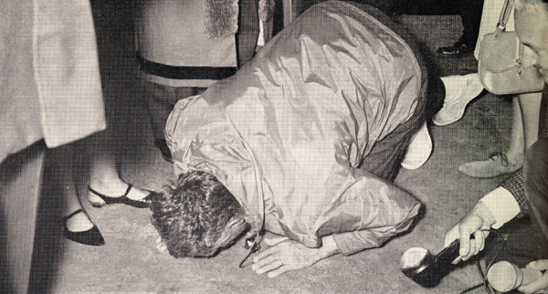 Photo of Manry kissing the ground