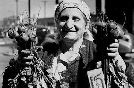 Vendor Rose Thomas showing off her beets at the West Side Market, 1947