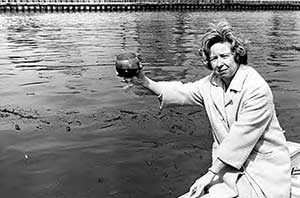 Betty Klaric holding water sample from Cuyahoga River