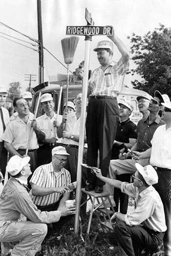 Mayor Day paints sign posts