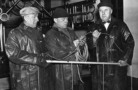 Parma firefighters holding equipment, 1939