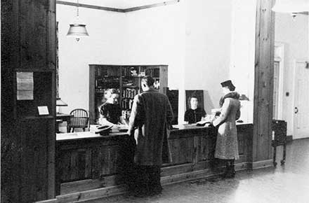 Librarian Mary Lee Scriven at Circulation Desk, Shaker Heights Public Library, circa 1938.
