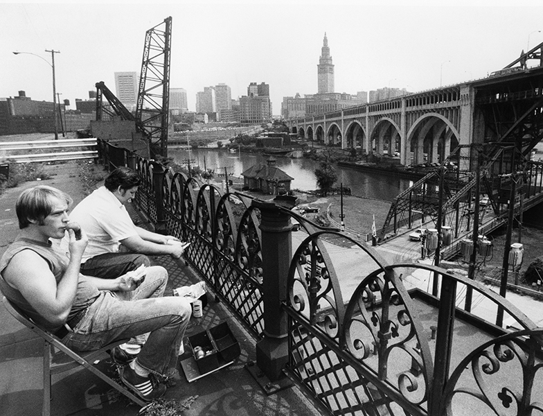 Two men on an old viaduct, eating lunch, by William Wynne.