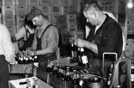 Pilsener Brewery workers pack cases of P.O.C. beer, 1933