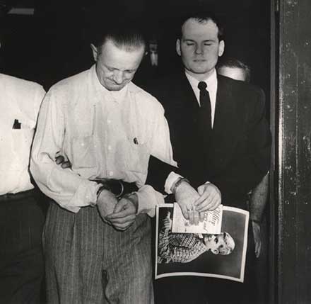 Convicted Dr. Samuel Sheppard is led away to a car, 1955