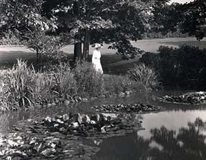 Elisabeth Severance Allen Prentiss standing next to a pond at Glenallen