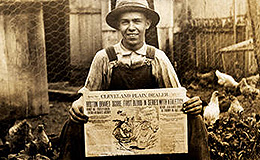Man holding the Cleveland Plain Dealer from October 1914