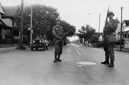 Ohio National Guardsman patrolling Hough Avenue during the daytime on July 23, 1966