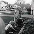 Carolyn Hufford center with sister and father in garden